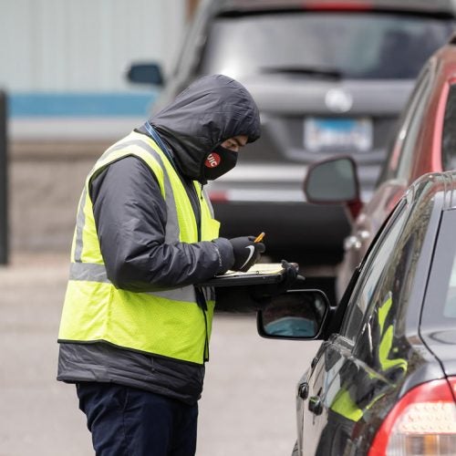 Alfonzo Cantu, a COVID-19 outreach specialist, surveys Chicagoans in a Walgreens parking lot in the Mayfair neighborhood on Wednesday, April 21, 2021, in Chicago, Ill.