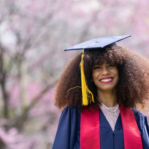 Black woman wearing graduation gown and cap