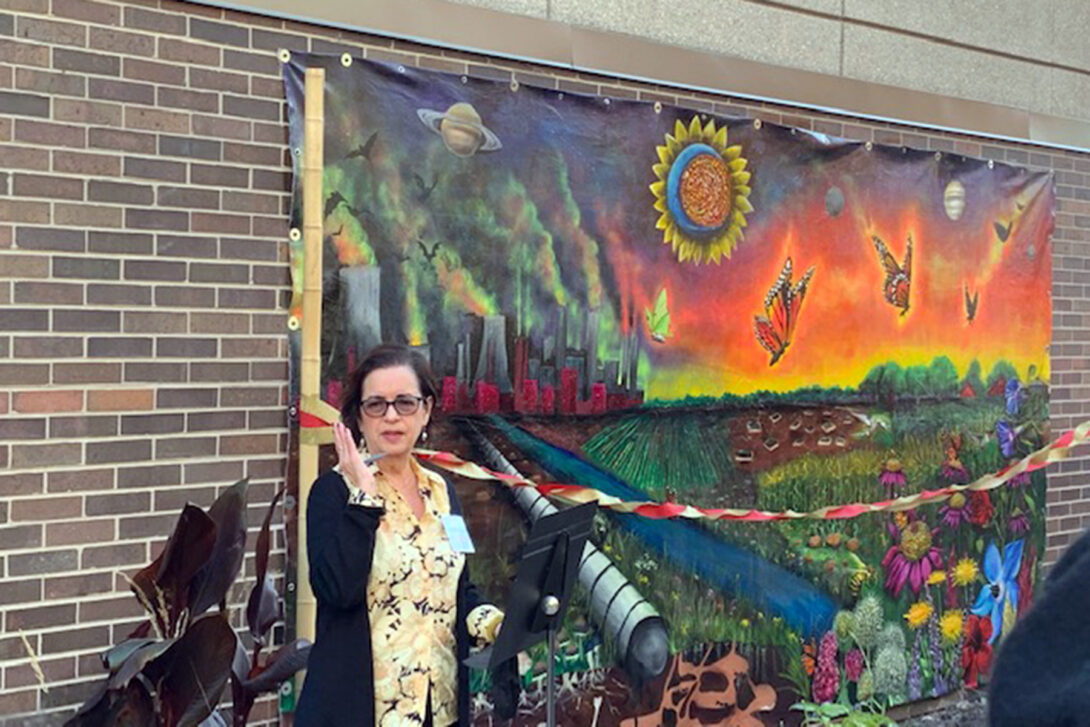 Rosa Cabrera in front of the mural.