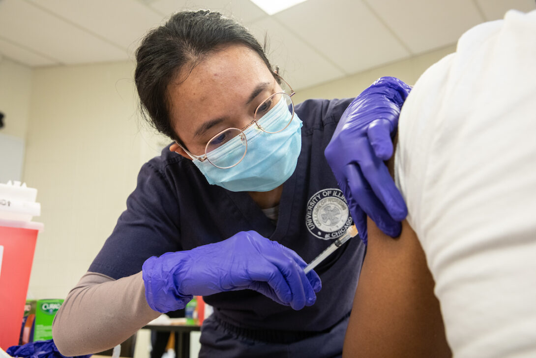 Nursing student administers a shot on a patient