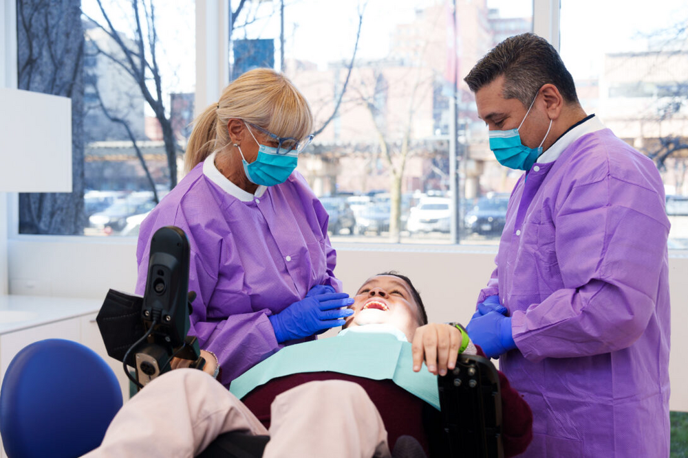 Clinicians performing dental work on a patient