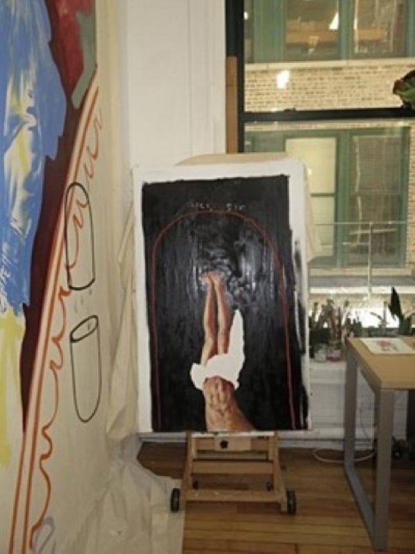 An unfinished painting in Matt's studio, featuring an upside down image of a man's legs and torso.