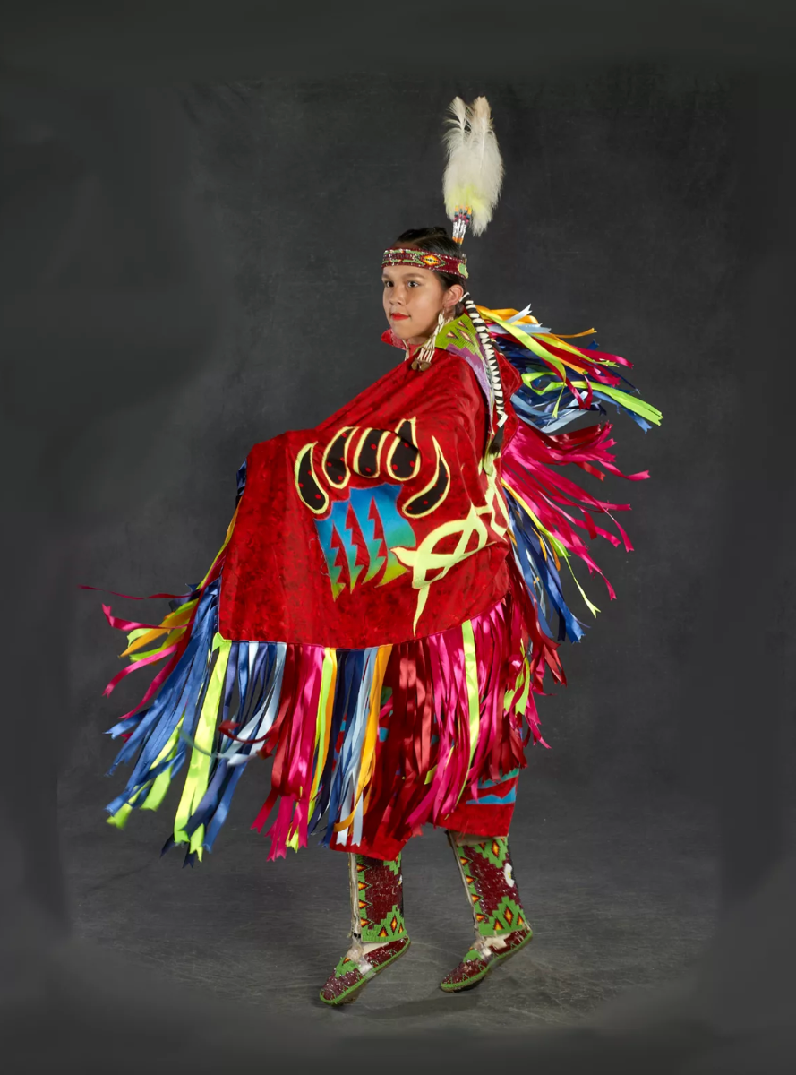 A Native American dancer in colorful traditional attire