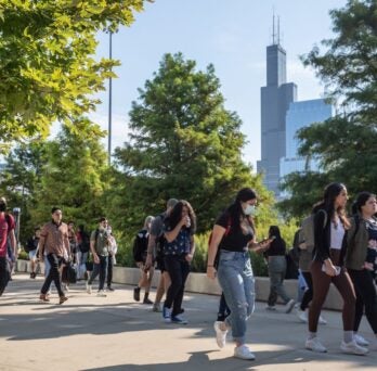 Students walking on campus with Willis Tower in background 