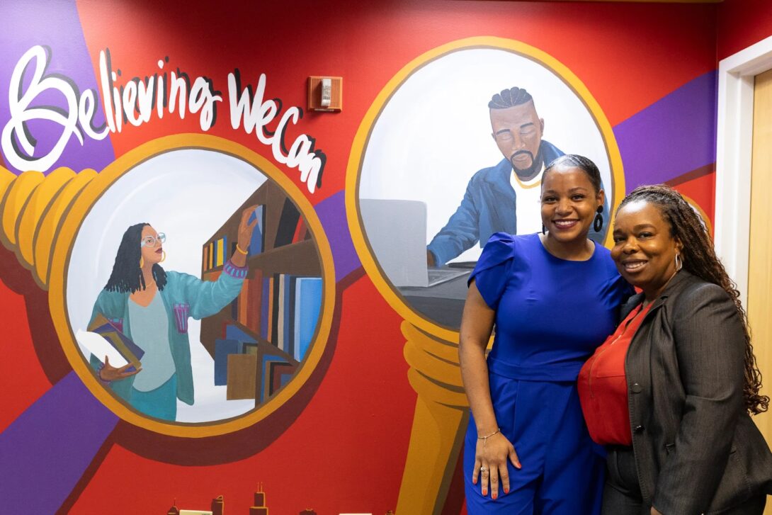 Artist Leah Renee (left) and Aginah Muhammad, assistant vice provost for student success, at the African American Academic Network mural