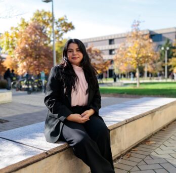 Monica Padilla sitting outside on UIC's East Campus 